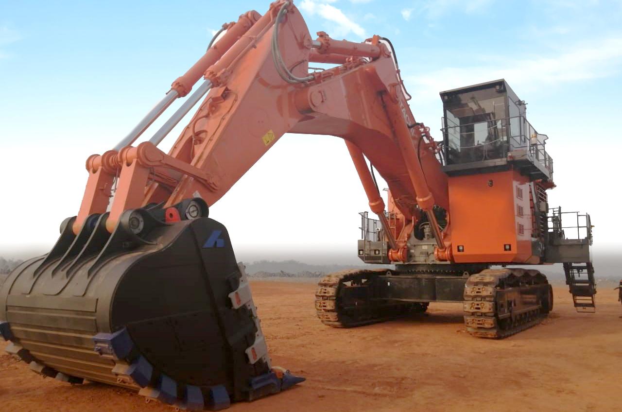 An orange mining excavator with a black bucket with the blue Bradken logo on it
